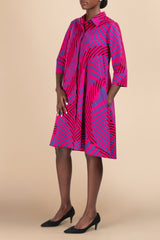 Model wearing Dutch-wax cotton shirtdress, side view